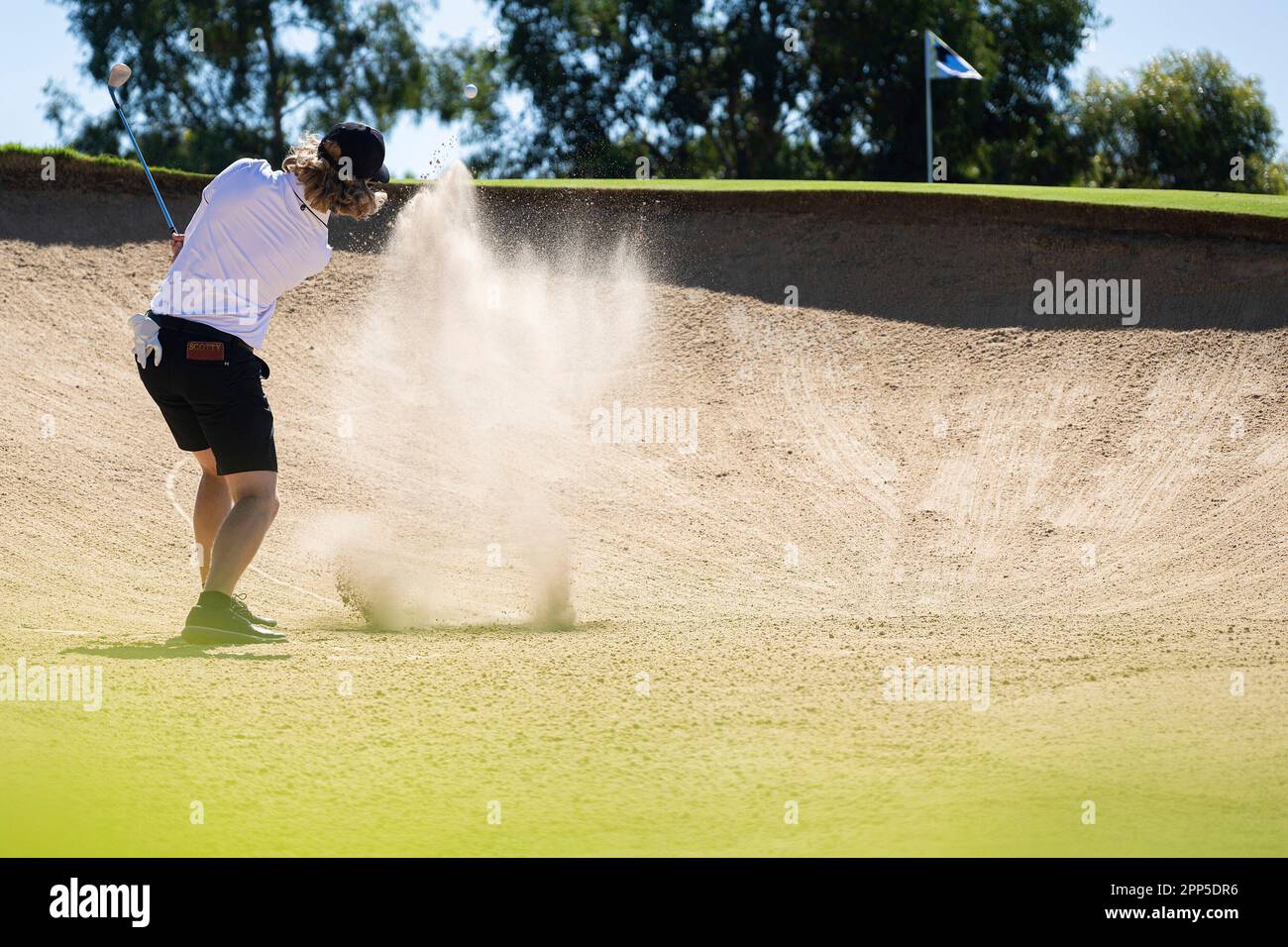 Scott Vincent of Iron Heads GC hits his shot from a bunker on the
