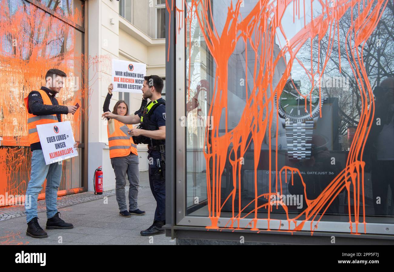 22 April 2023, Berlin: Activists of the environmental group Last Generation hold posters in front of a luxury store. Previously, they had sprayed the facade with paint. The police took down the personal details after the act. 'The richest Germans emit a thousand times more greenhouse gases than the average. While the ordinary people have to bear the consequences, a few can buy their way out of the catastrophic consequences of the climate catastrophe, which they have significantly contributed to, for a long time to come,' said a statement from the Last Generation on the protest action. Photo: P Stock Photo