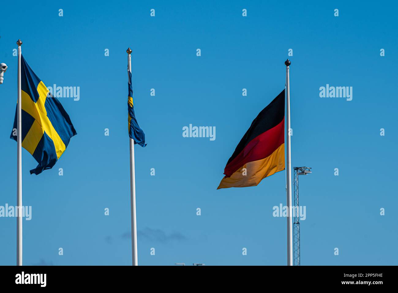 Swedish and german flag on flag poles Stock Photo - Alamy