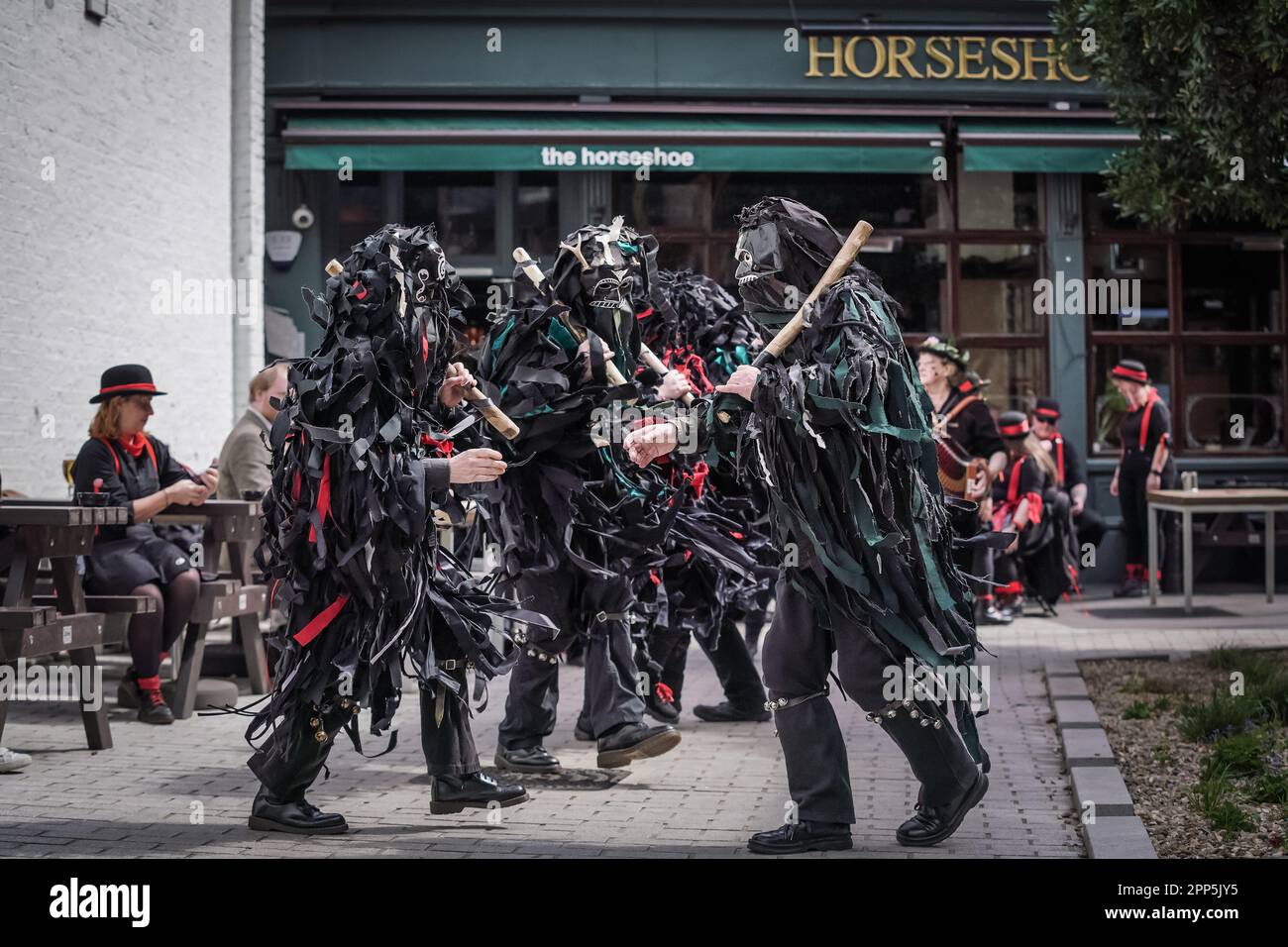 The Wild Hunt Bedlam Morris perform outside The Horseshoe Inn, Bermondsey as part of St. George’s Day festivities and summer Morris traditions. Stock Photo