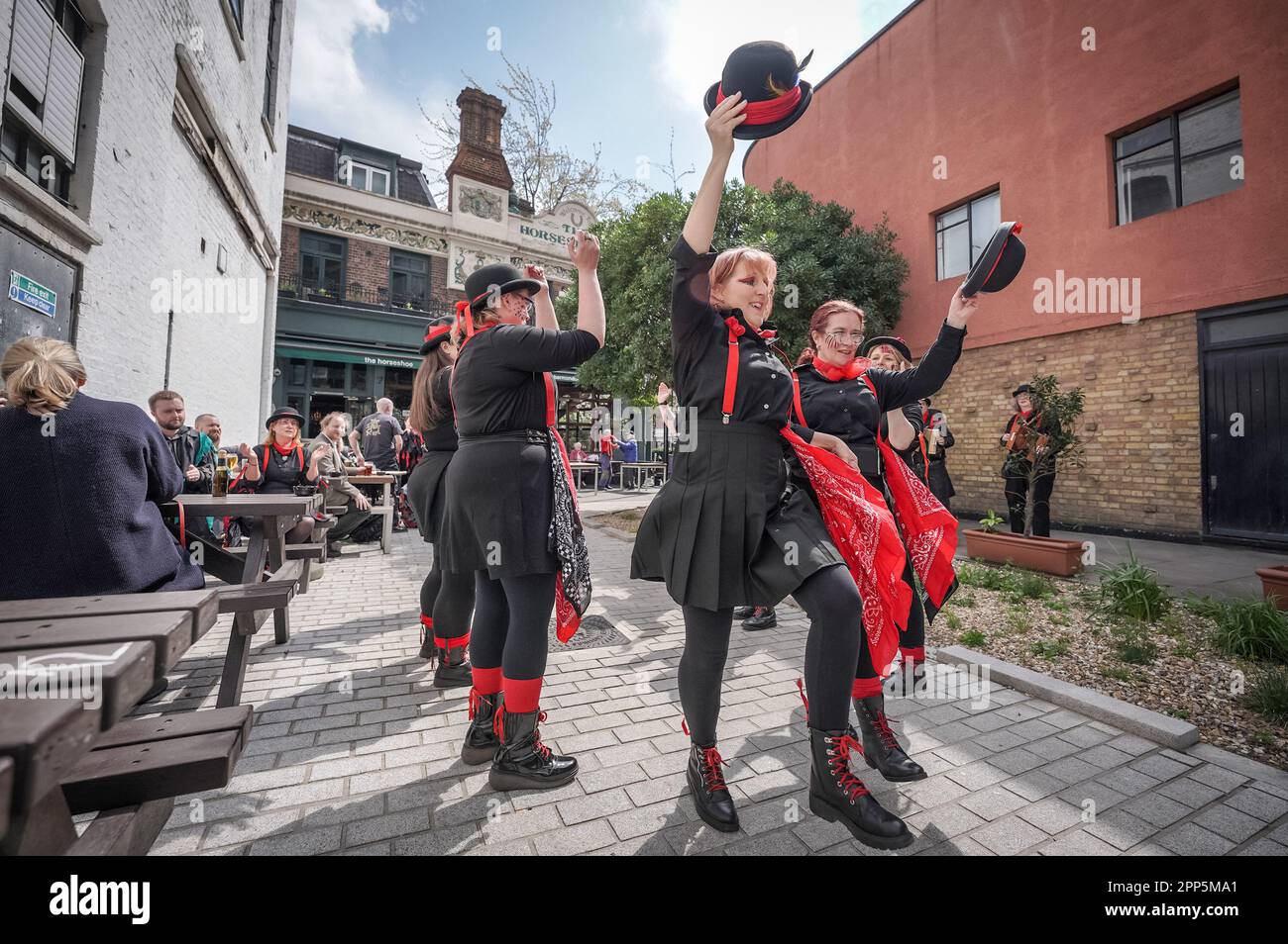 Madder Mill Molly perform outside The Horseshoe Inn, Bermondsey, London as part of up-coming St. George’s Day festivities and summer Morris traditions Stock Photo