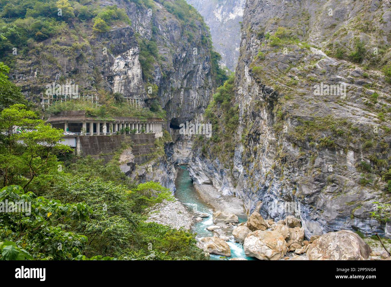 Swallow Grotto Yanzikou Trail with narrow turquoise Liwu River Gorge underneath and high mountain cliff face in Taroko National Park, Xiulin Township, Stock Photo