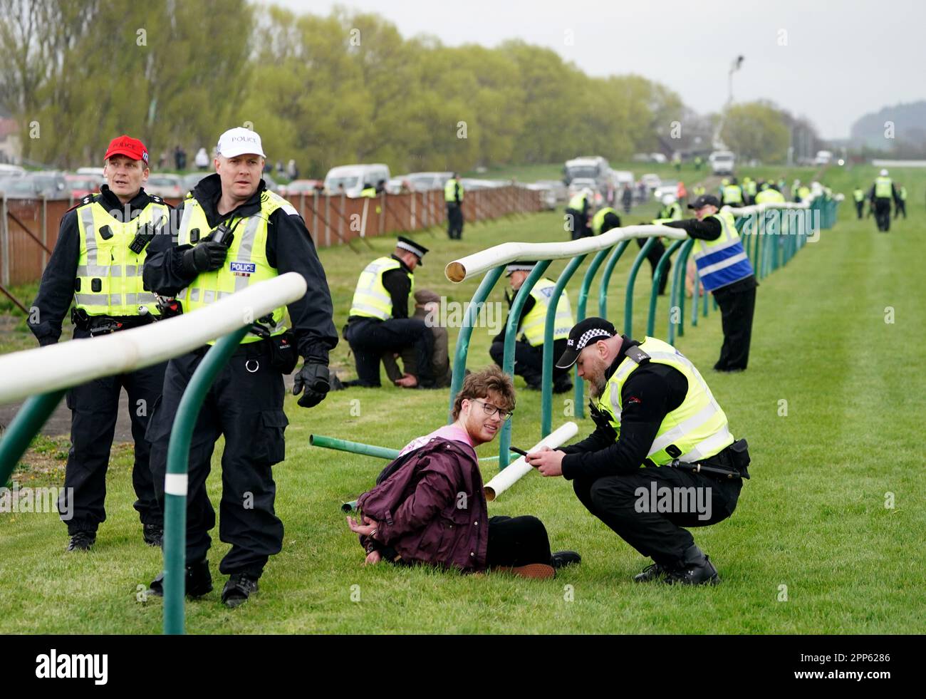 Animal Rising activists are apprehended by police officers as they ...