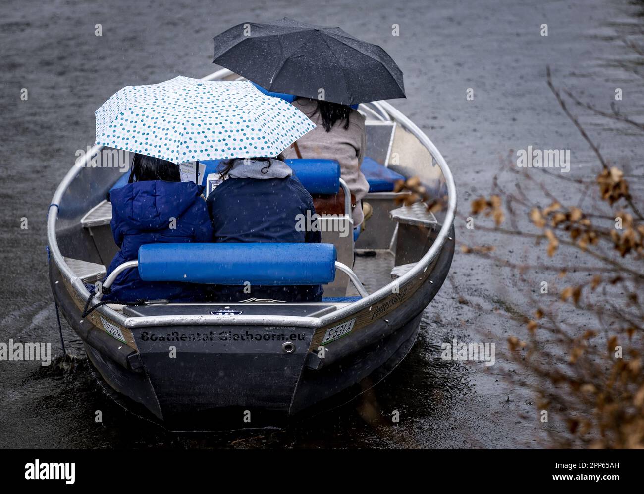 GIETHOORN - Tourists sail in a boat through the rain in Giethoorn during  the May holiday. The water region village is a popular destination for  tourists and day trippers. ANP SEM VAN