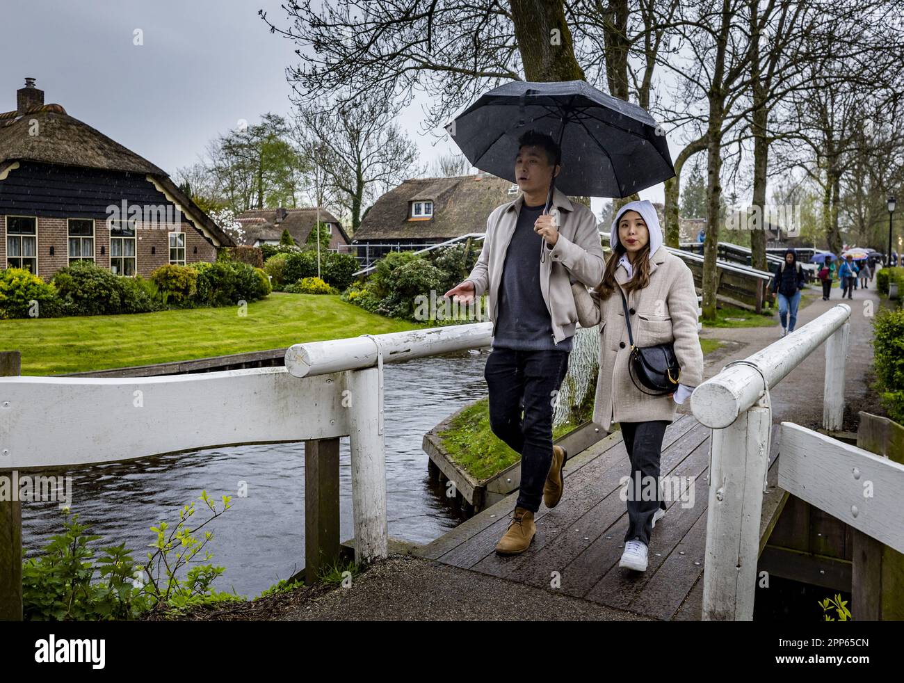 GIETHOORN Tourists walk through Giethoorn in the rain during the May