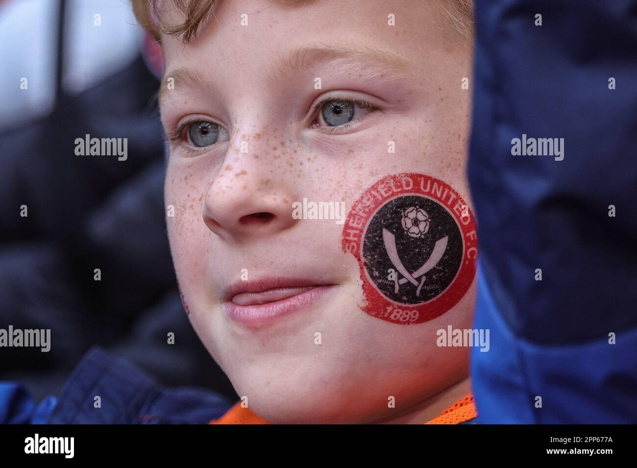 A young fan with a painted Sheffield United logo their cheek during the Emirates FA Cup Semi-Final match Manchester City vs Sheffield United at Wembley Stadium, London, United Kingdom, 22nd April 2023  (Photo by Mark Cosgrove/News Images) Stock Photo