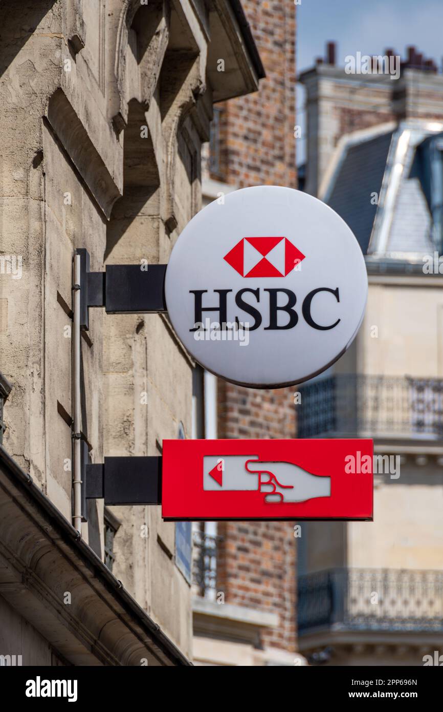 Sign and logo of a French branch of the British international banking group HSBC indicating the presence of an ATM Stock Photo