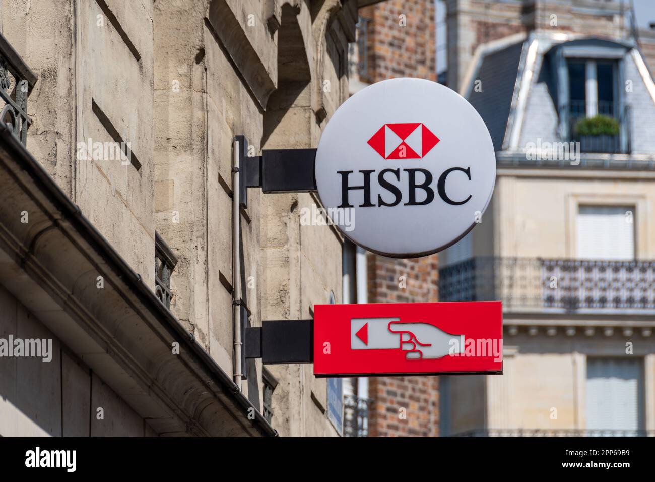 Sign and logo of a French branch of the British international banking group HSBC indicating the presence of an ATM Stock Photo