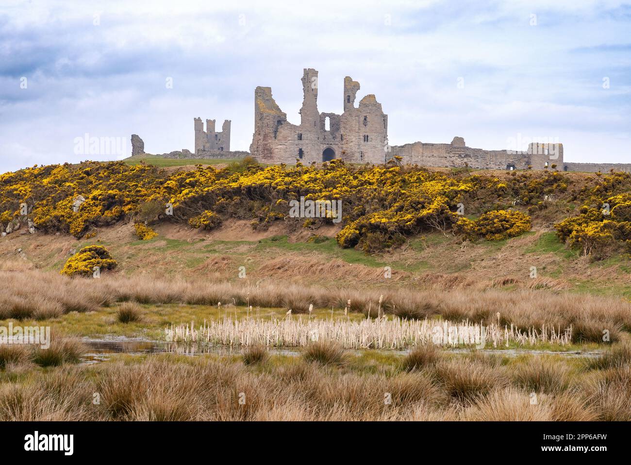 Dunstanburgh Castle; 14th century medieval ruined castle on the Northumberland coast between Low Newton and Craster; Northumberland UK landscape Stock Photo