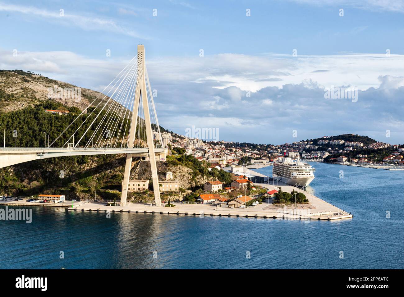 Franjo Tuđman Bridge, Dubrovnik, Croatia, a cable-stayed bridge opened in 2002 and Dubrovnik Harbour, with a cruise liner moored up. Stock Photo