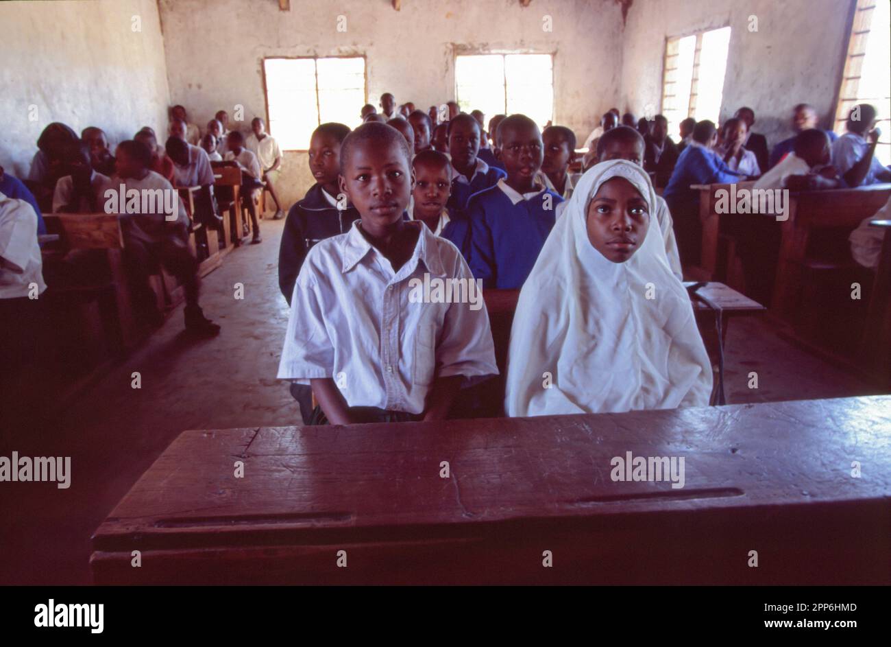 Young students wearing uniform in a simple classroom near Nairobi, Kenya. Africa Stock Photo