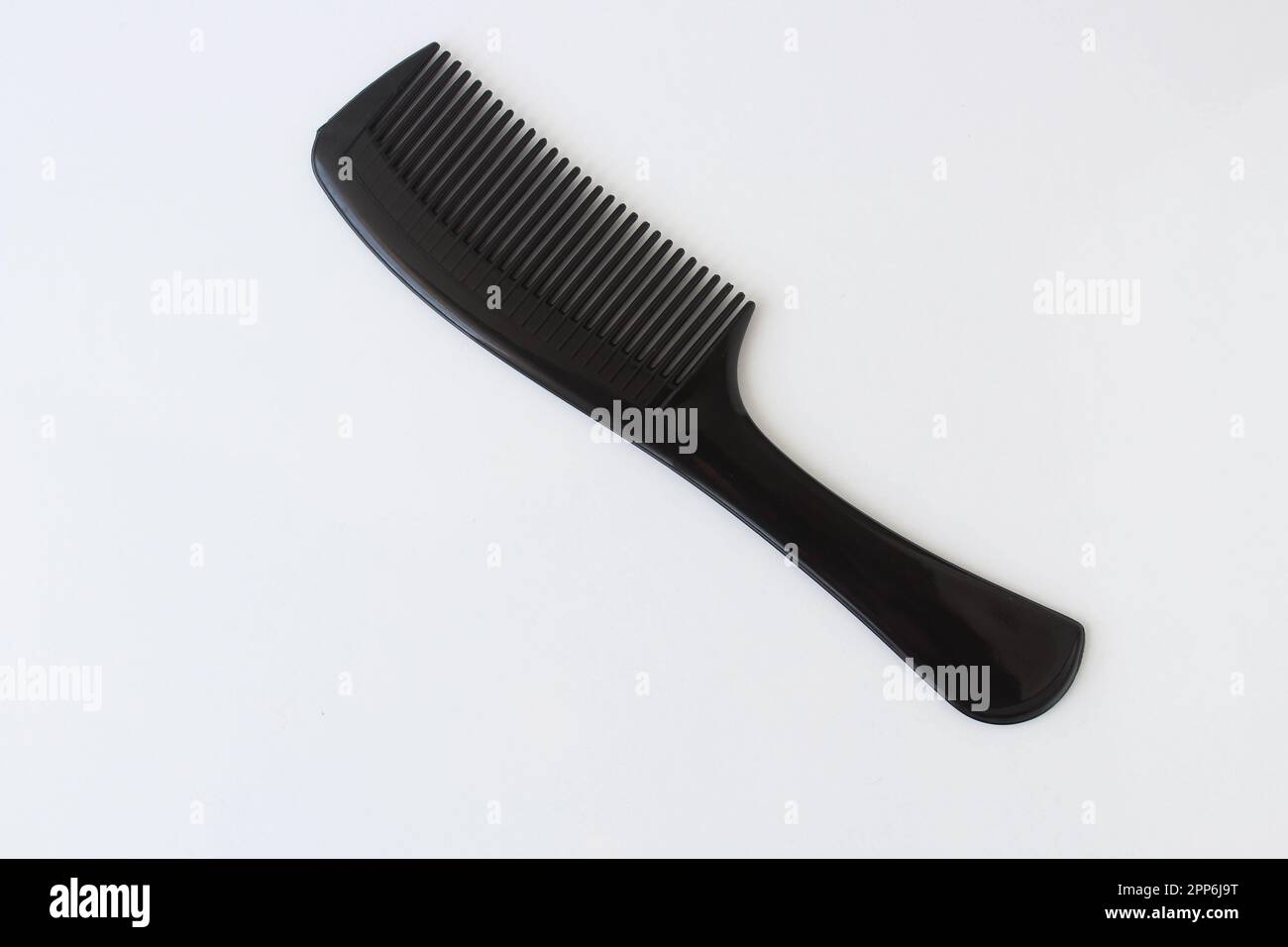 Top view on black color plastic hairbrush isolated on white background