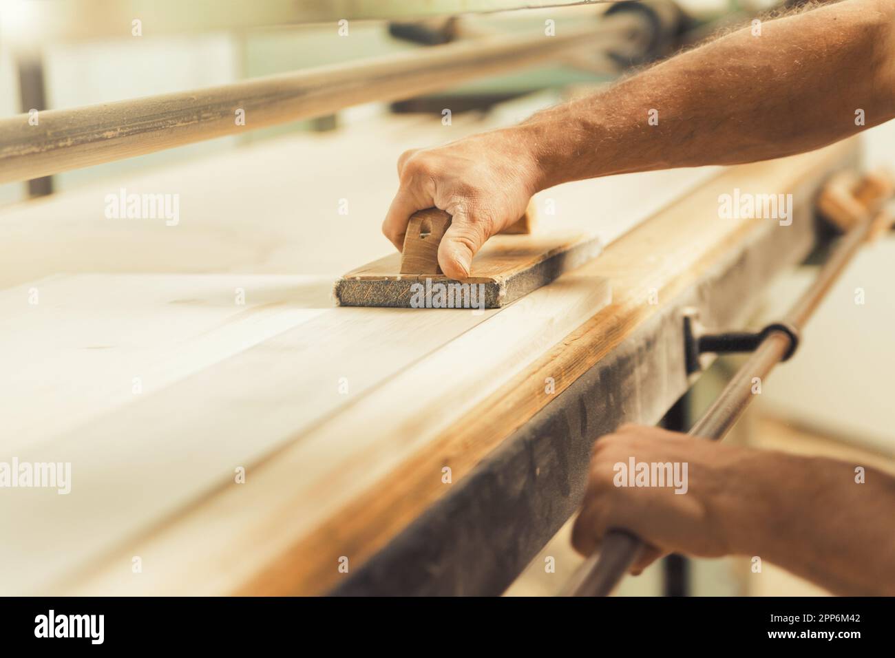 The professional woodworker uses a modern planer or sander with a