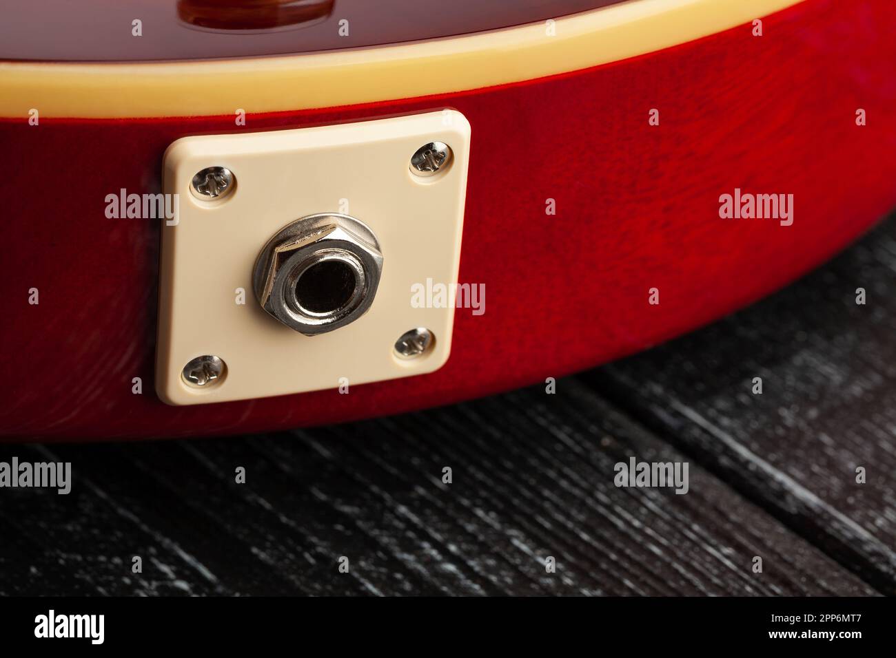 guitar output jack on wood background Stock Photo