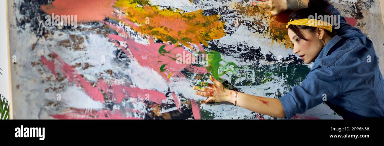 Paint Working Inspired woman, female painter working on a large modern abstract oil ...