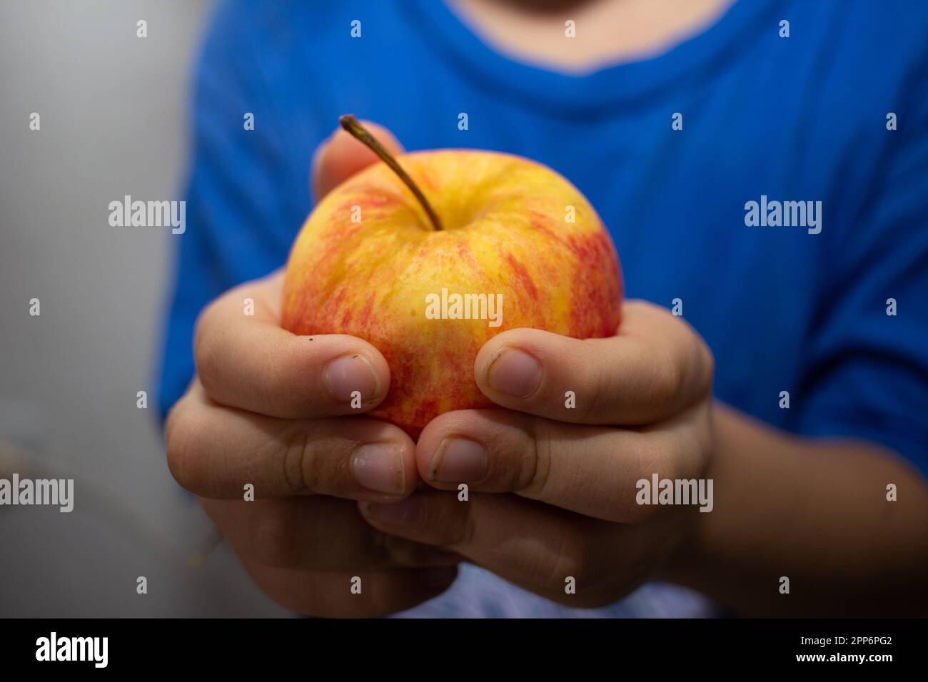 boy holds red apple Stock Photo Alamy