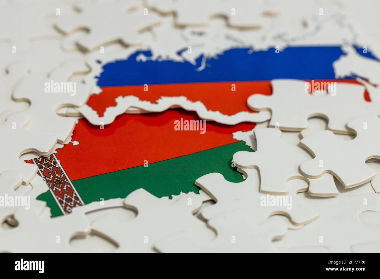 Flags of Russia and Belarus among scattered puzzle pieces, Concept of Geopolitical puzzle, military and economic alliance of both countries Stock Photo