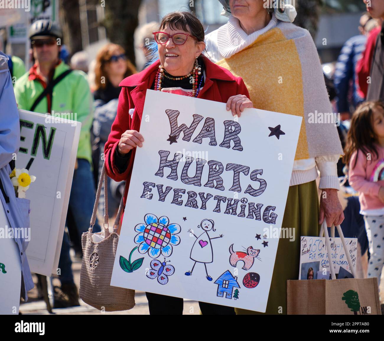 Halifax, Canada. April 22, 2023. War hurts everything sign as Hundreds walked along the harbour in the annual Earth Day Parade in Halifax Nova Scotia. Under the theme “The People's Parade for Life on Earth '' it gathered participants demanding action to preserve our planet. Credit: meanderingemu/Alamy Live News Stock Photo