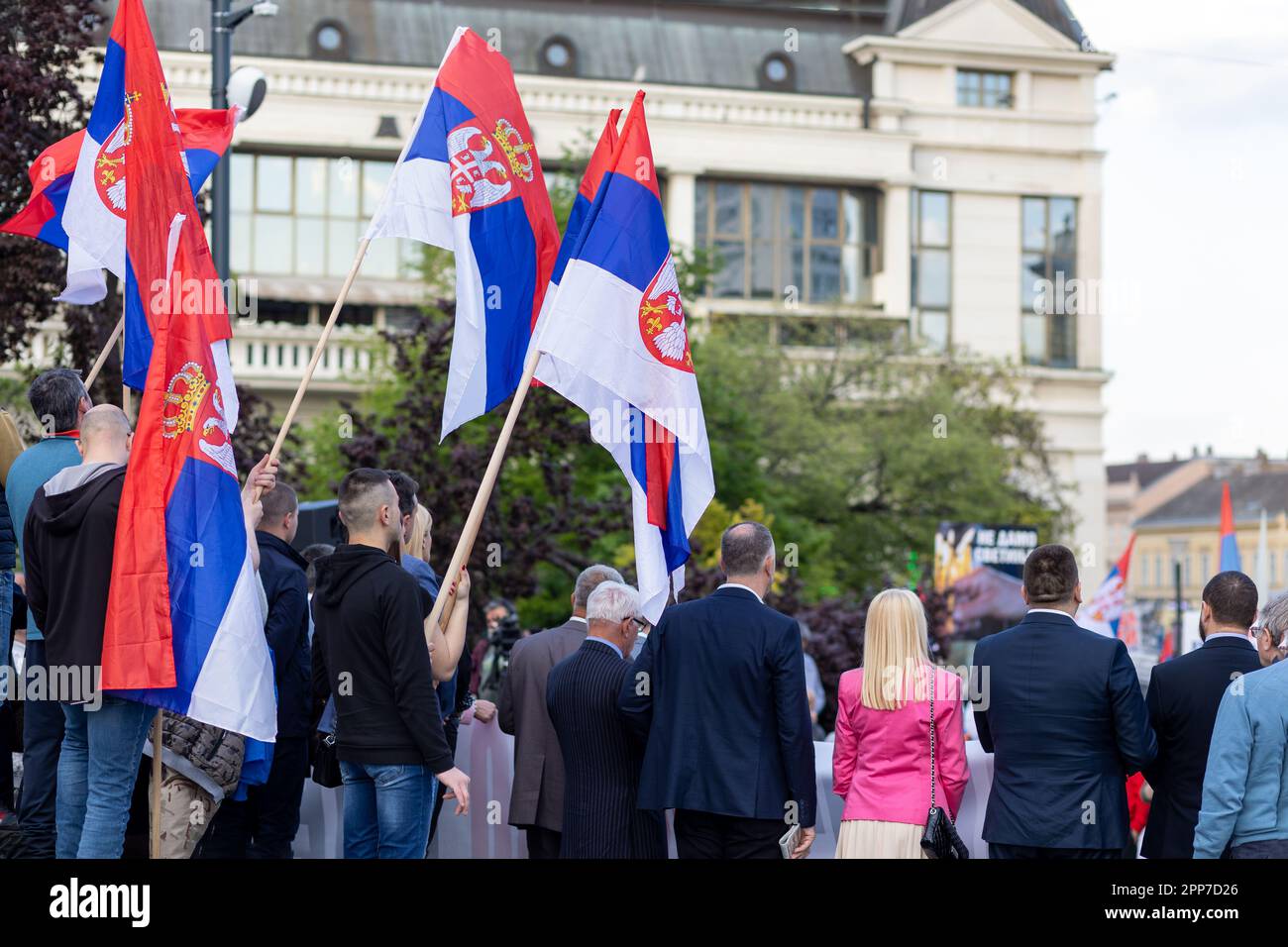Political rally of people in front of main building. Back view of ...