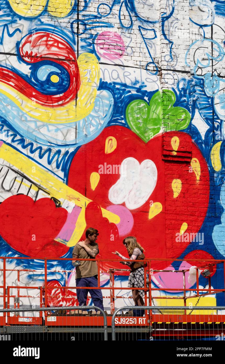 Mural artists discussing a detail in Liverpool Stock Photo Alamy