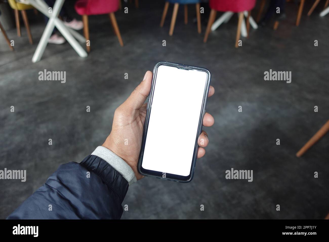young man hand using smart phone with green screen at cafe Stock Photo ...