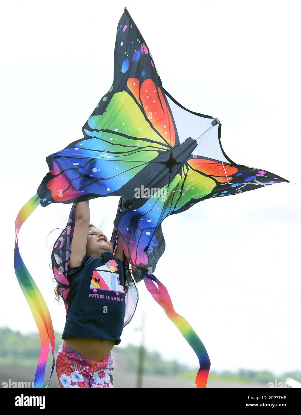 Local resident Penny Haber, 4, launches a butterfly kite during