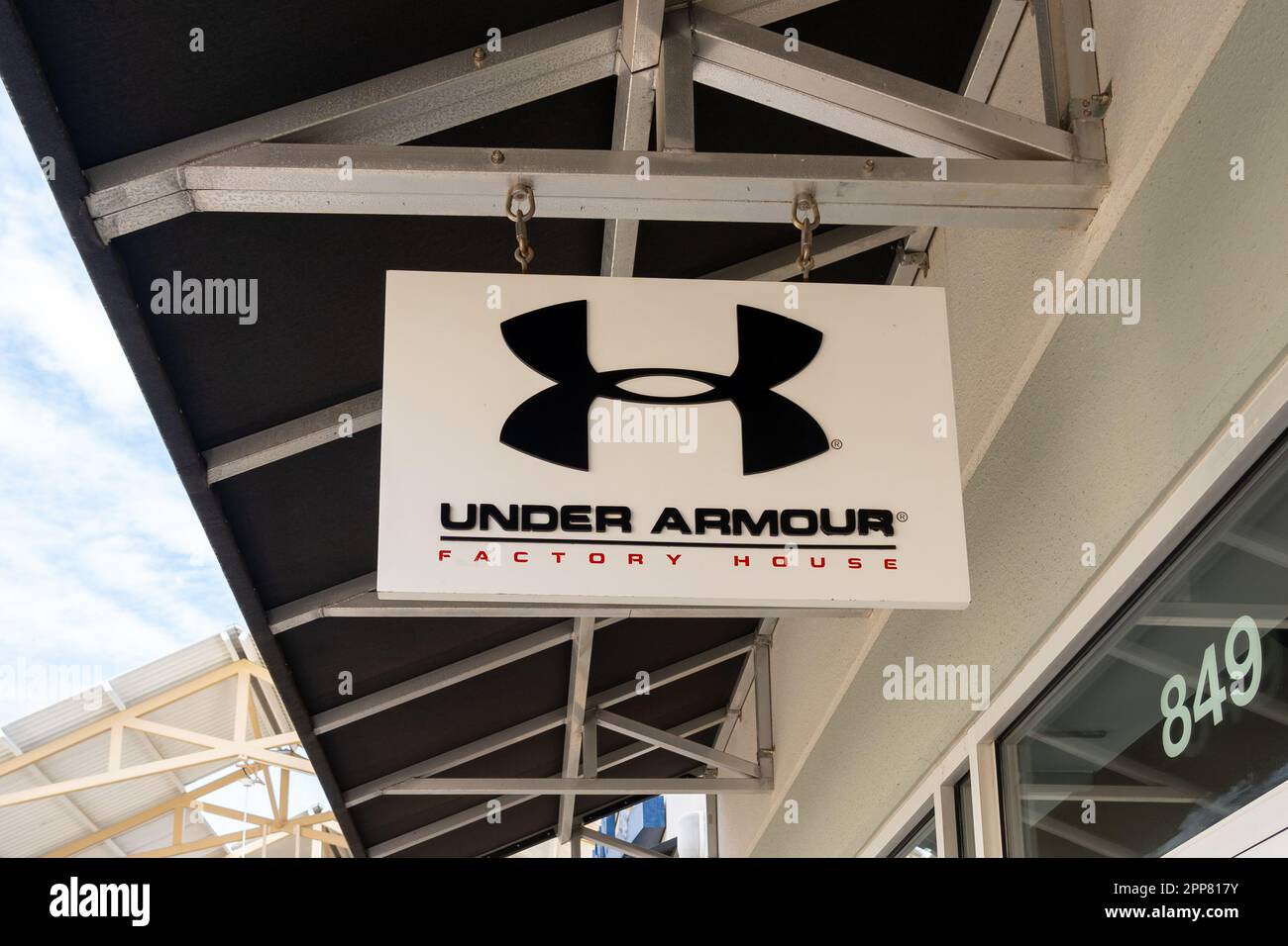 Under Armour Outlet Mall.Close up of Under Armour store hanging sign is seen at an outlet mall ...