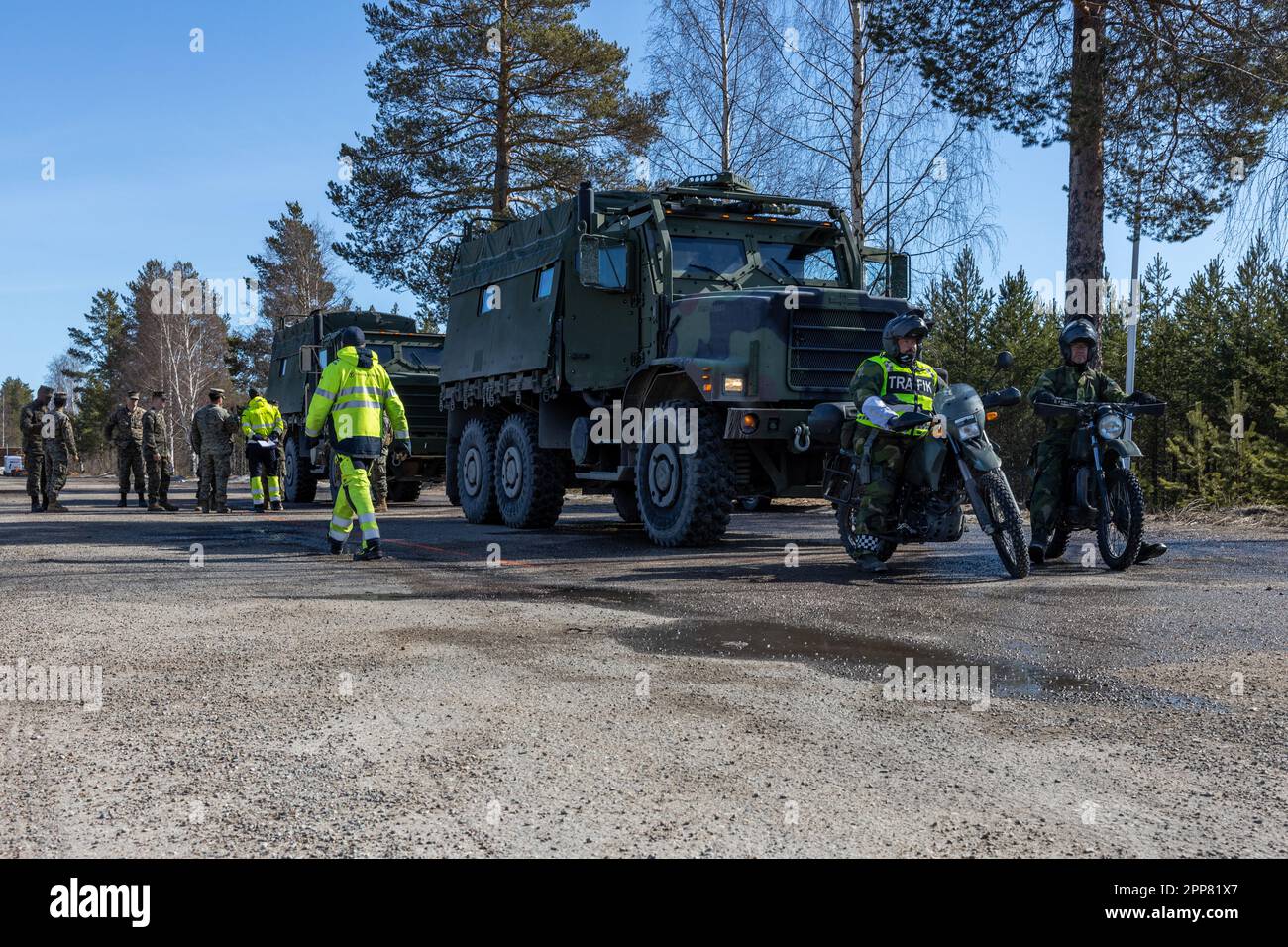 U.S. Marines with 2d Combat Engineer Battalion, 2d Marine Division, and Swedish Northern Military District soldiers stage vehicles before ferry crossing operations near Sveg, Sweden, April 18, 2023. Marines are deployed to Norway as part of Marine Rotational Forces Europe 23.1 which focuses on regional engagements throughout Europe by conducting various exercises, arctic cold-weather and mountain warfare training, and military-to-military engagements, which enhance overall interoperability of the U.S. Marine Corps with allies and partners. (U.S. Marine Corps photo by Sgt. Christian M. Garcia) Stock Photo