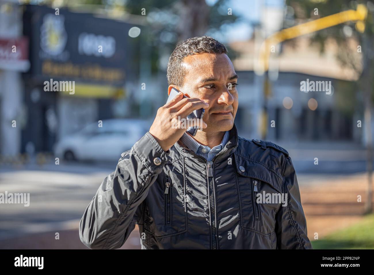 Portrait of a young latin man talking on a mobile phone. Stock Photo