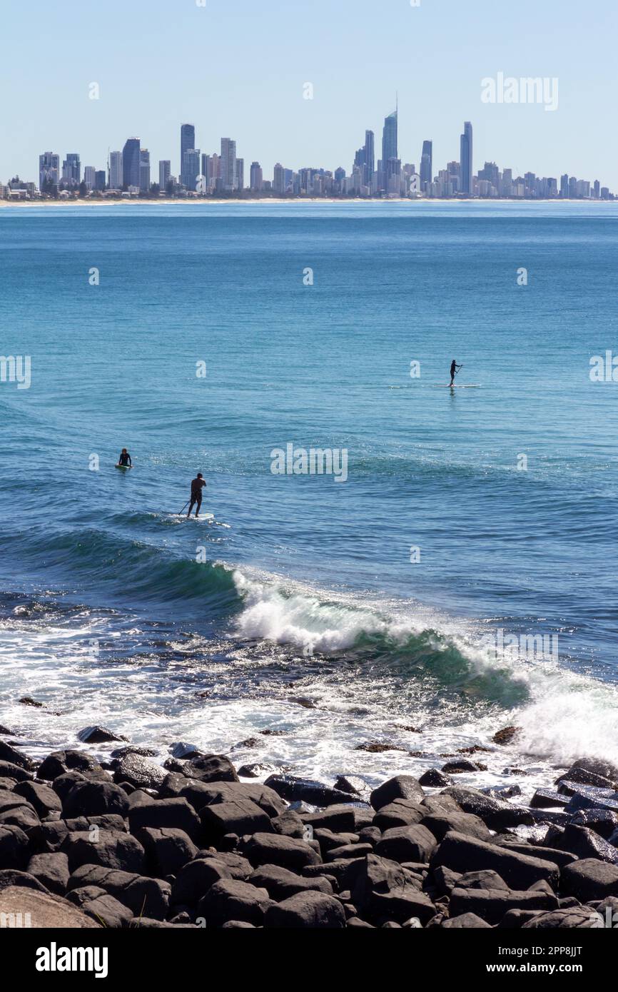 Paddleboarders at Burleigh Beach, Gold Coast, Queensland, Australia Stock Photo