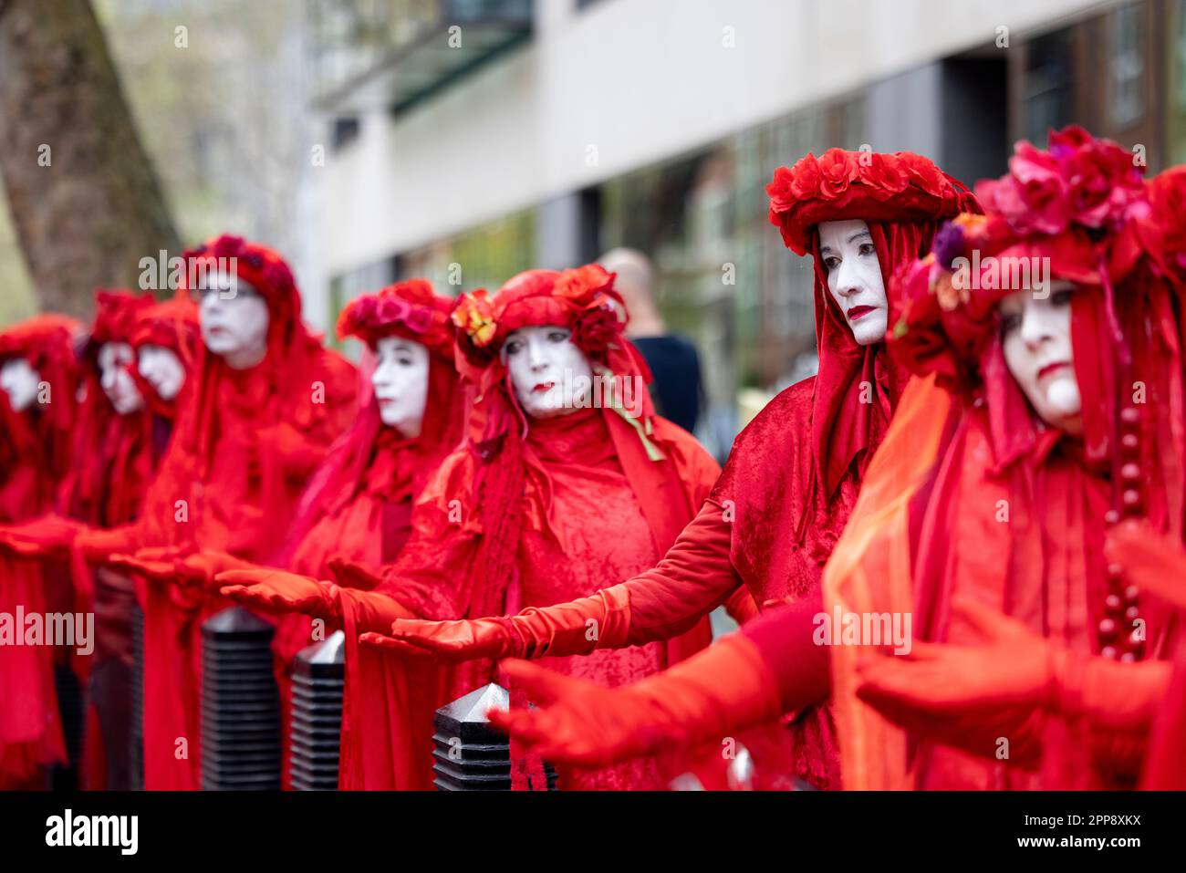 London, UK. 22nd Apr, 2023. Protesters seen dressing as red brigades to urge the UK government to view climate crisis as a matter of emergency during the march in Westminster. Extinction Rebellions, a mass group of activists from different discipline with their primary concern on climate crisis, continue the second day of their mass campaign on the Earth Day. This is the first campaign since the group pledged to move away from controversial disruptive methods since late last year. Credit: SOPA Images Limited/Alamy Live News Stock Photo