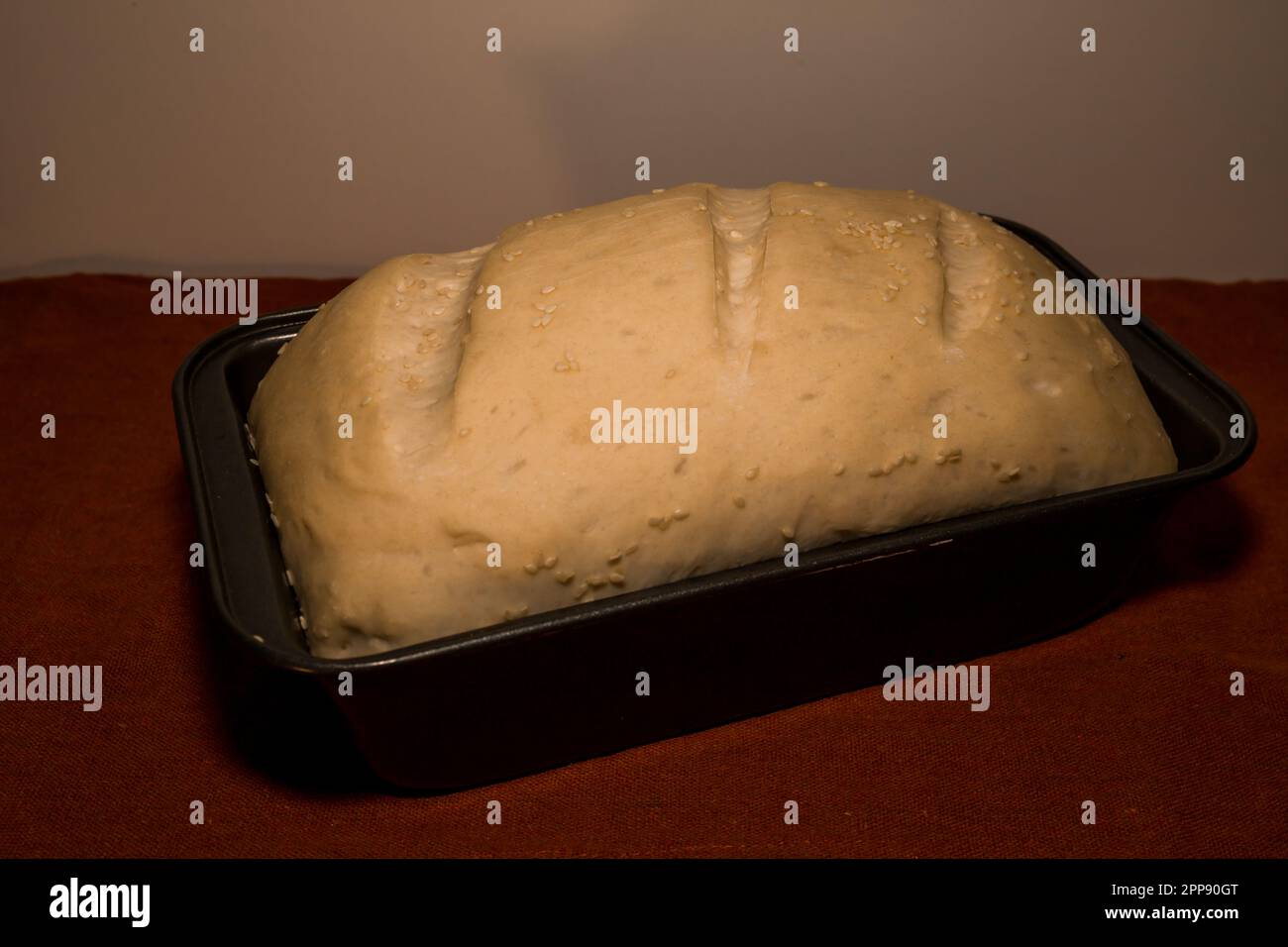 Woman using a dough cutter to divide the naan bread dough into six equal  portions which are flattened and baked. Bakers and pas Stock Photo - Alamy