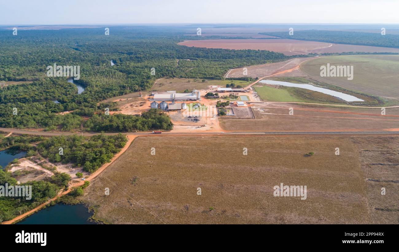 Aerial view of agricultural landscape with a big farm, border to remaining rainforest, signs of deforestation, San Jose do Rio Claro, Mato Grosso, Bra Stock Photo