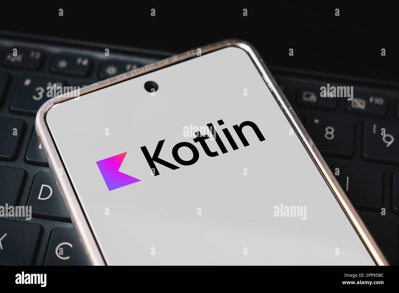 kotlin Programming language for mobile development, concept. Smartphone on the laptop keyboard. logo kotlin on the mobile phone screen. Barnaul. Russi Stock Photo