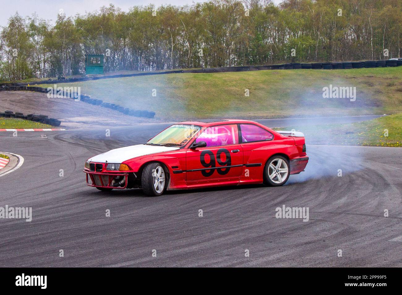 BMW Car No.99 burning rubber and tires screeching at Three 3 Sisters