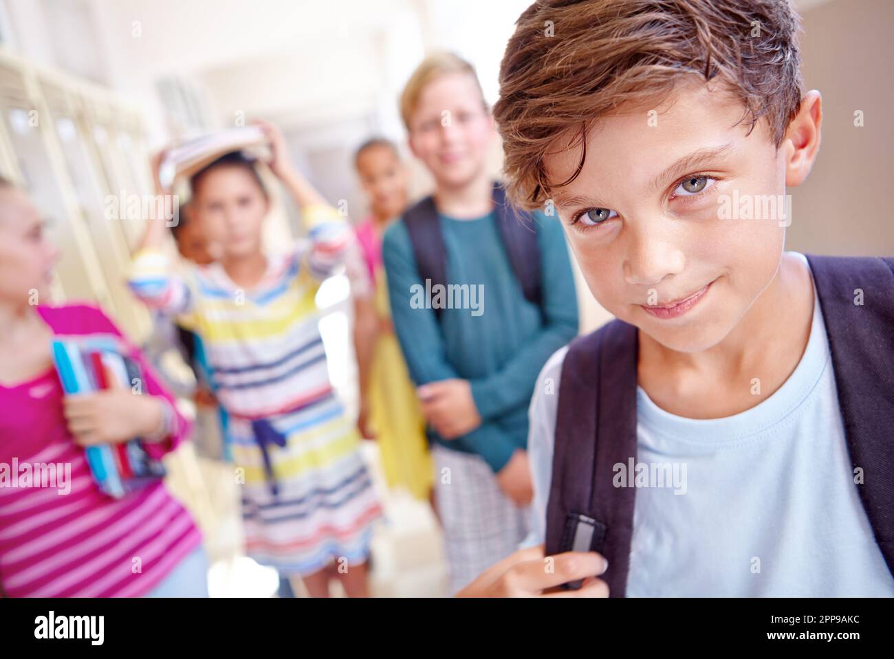 Head of the class. a young boy with his classmates standing in a