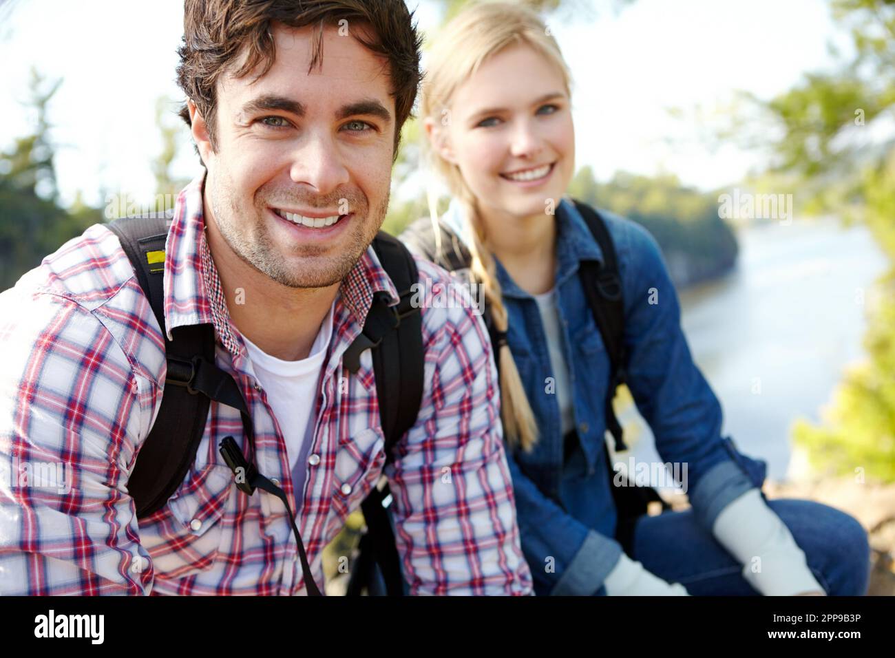 Im lucky shes an outdoorswoman. A handsome young man sitting out in nature with his girlfriend. Stock Photo