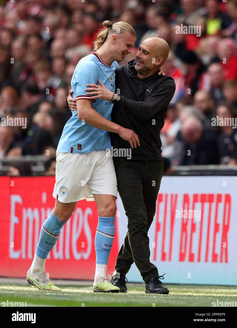 London, UK. 22nd Apr, 2023. Erling Haaland (MC) and Pep Guardiola (Man City manager) hug at the Emirates FA Cup Semi-Final Manchester City v Sheffield United match at Wembley Stadium, London, UK on 22nd April 2023. Credit: Paul Marriott/Alamy Live News Stock Photo