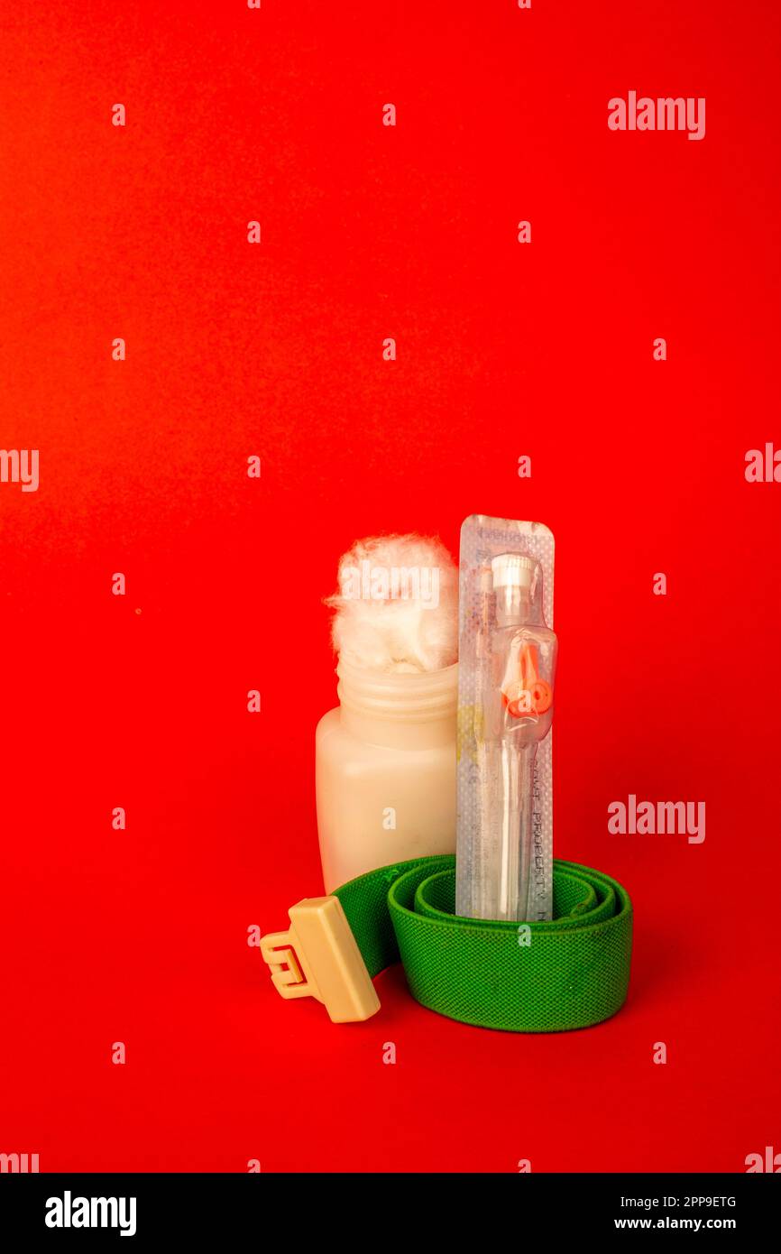 Cotton fiber texture in the white bottle with iv cannula . isolated on red background Stock Photo