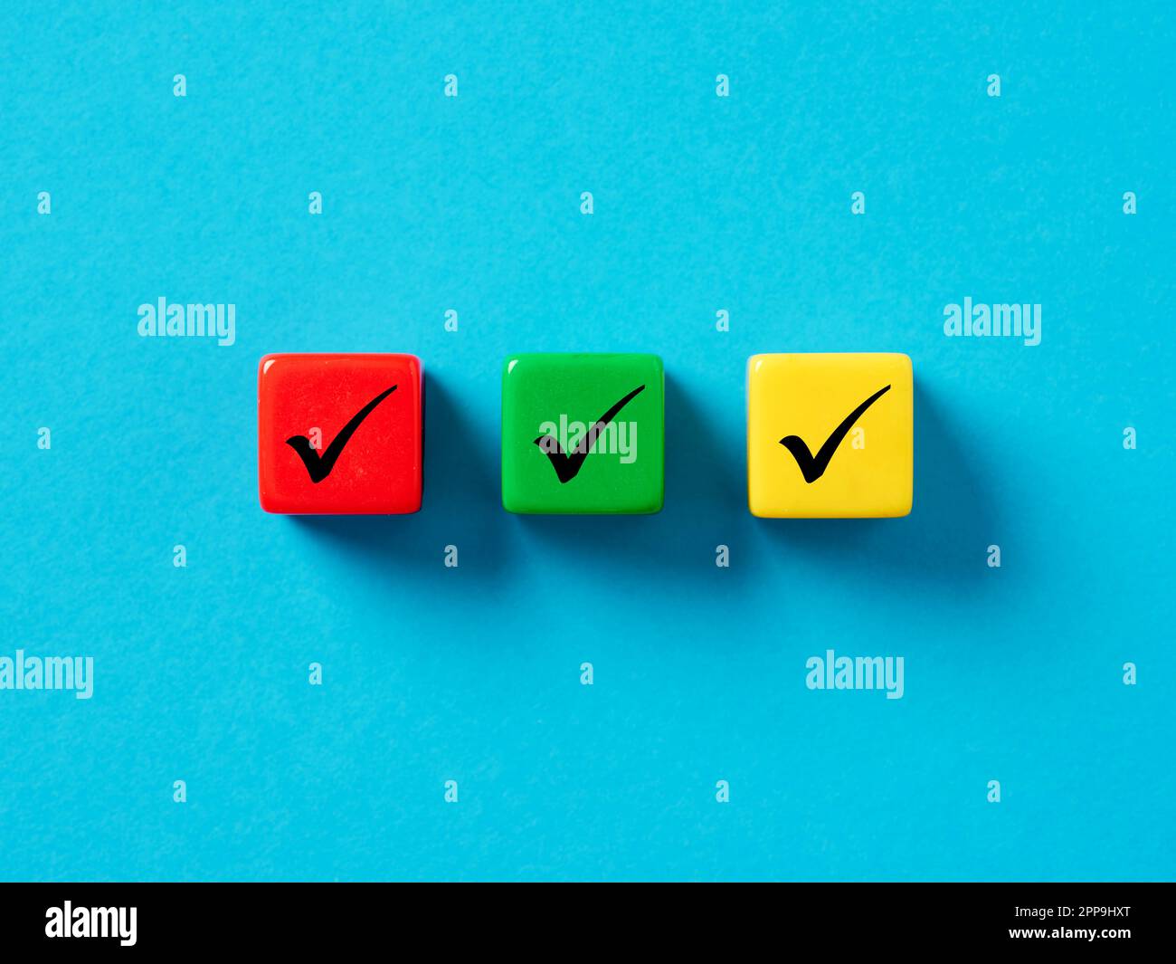 Checklist concept. Elections and Voting, Task list or task completion. Survey, and assessment concept. Check mark or tick symbols on colorful cubes. Stock Photo