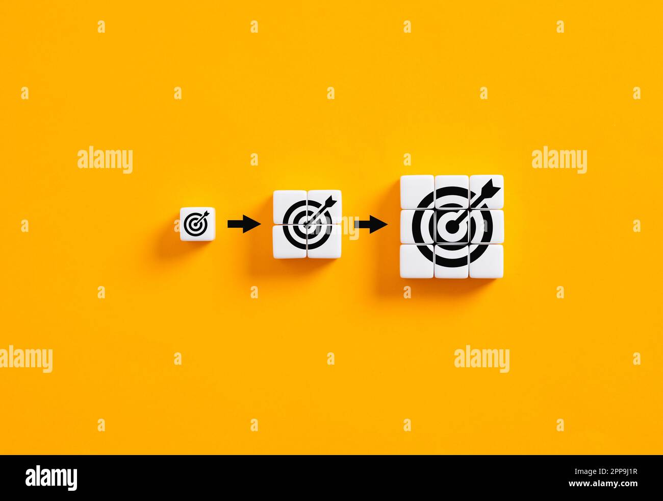 Setting business goals. Developing goals and objectives. Growing target symbols on white cubes