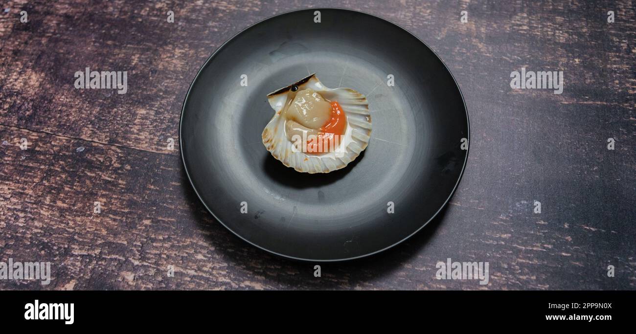 scallops au gratin cooked in the oven with parsley and lemon Stock