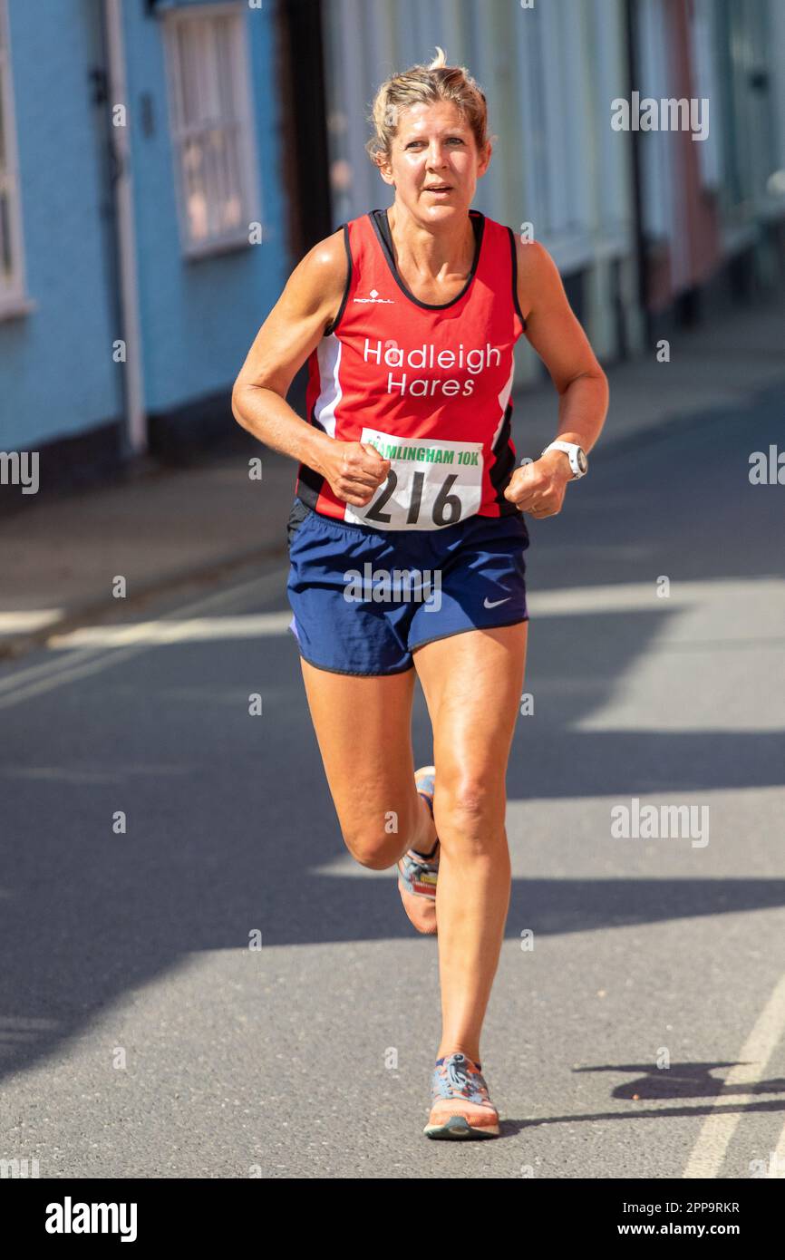Sun tanned woman club runner in the Framlingham Flyers 10km road race Stock Photo