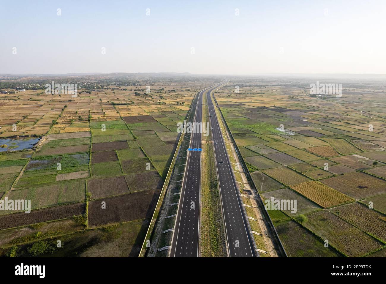 orbit aerial drone shot of new delhi mumbai jaipur express elevated highway showing six lane