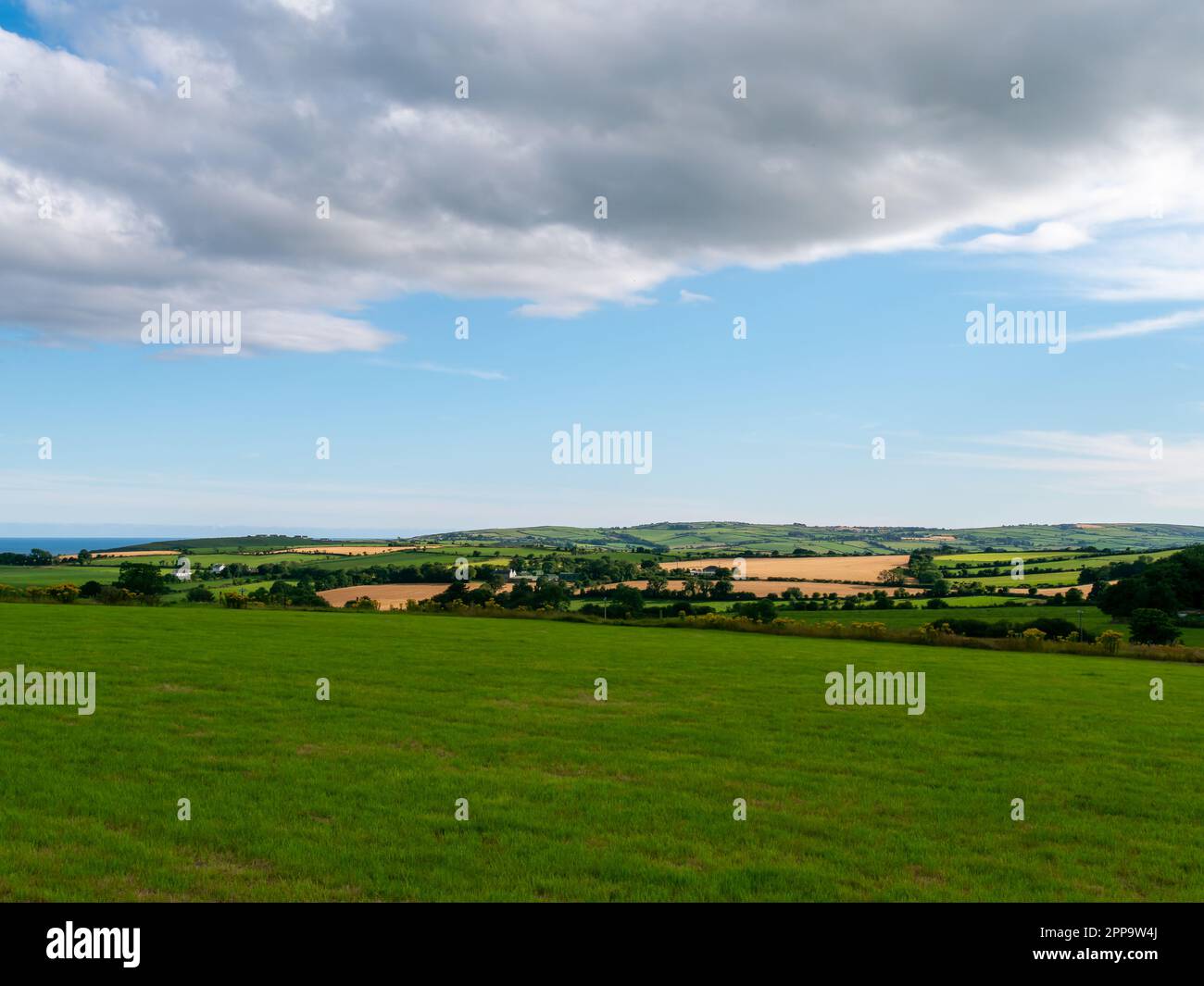 A huge grey cumulus cloud in the sky over the Irish countryside in ...