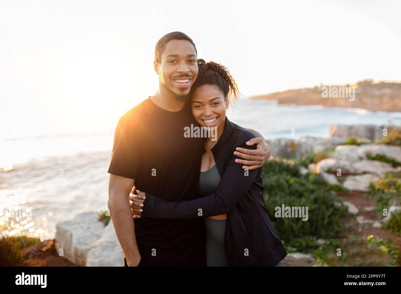 Positive millennial african american wife hugs husband in sportswear ...