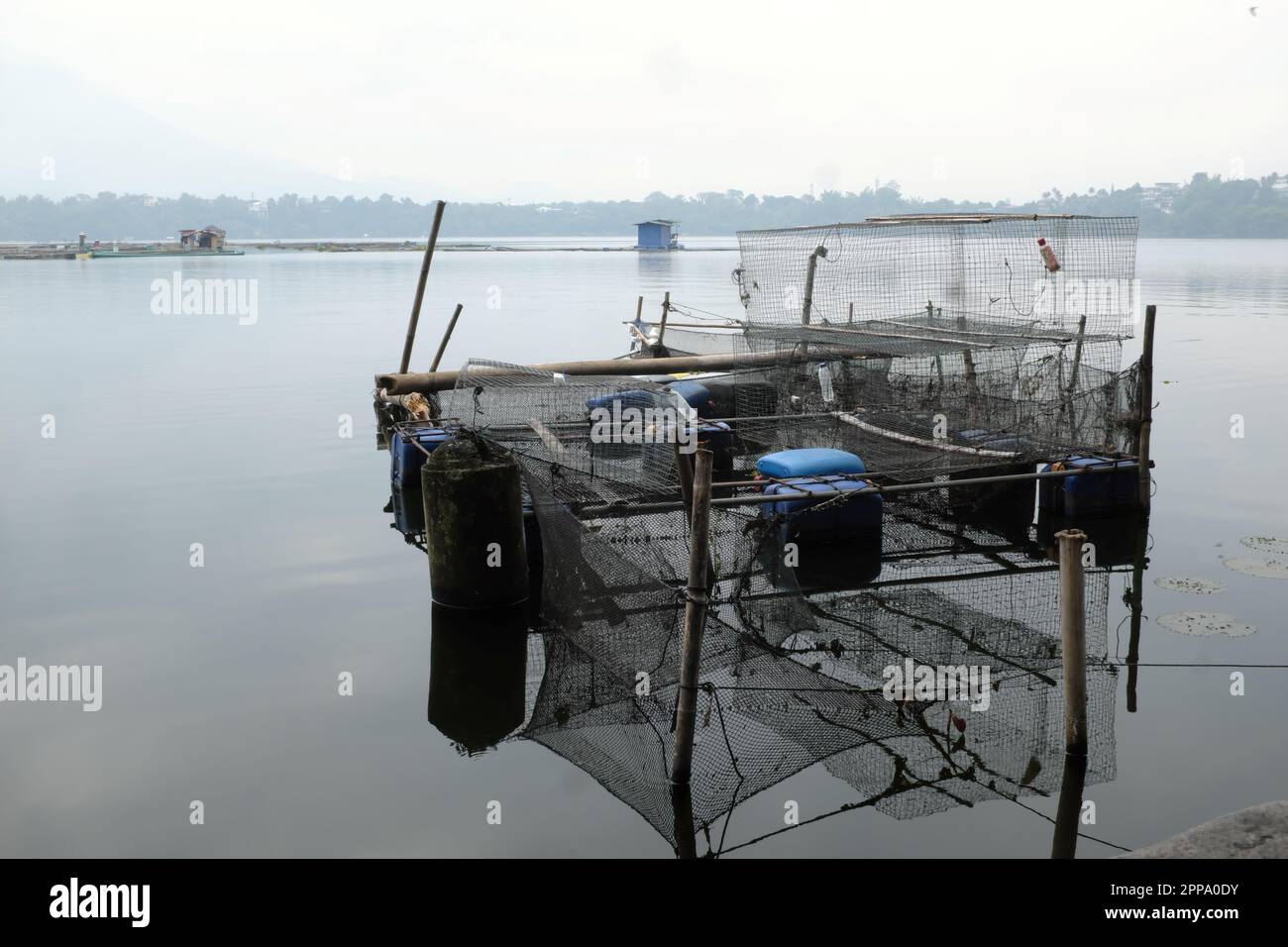 Floating fishpen or fish cage in Sampaloc Lake in San Pablo City, Laguna, Philippines. Stock Photo
