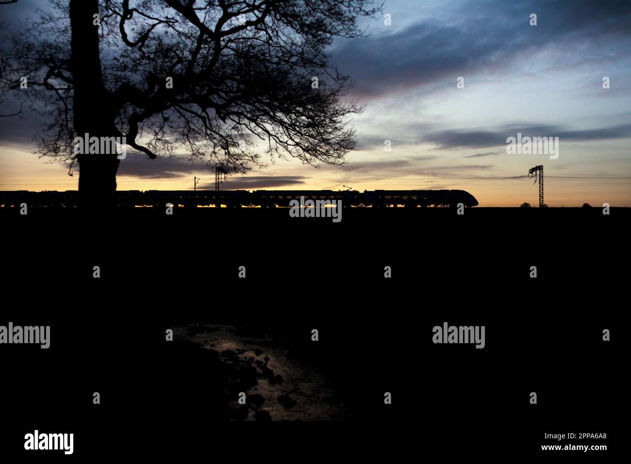First Transpennine Express CAF class 397 Nova 2 train on the west coast mainline at sunset Stock Photo