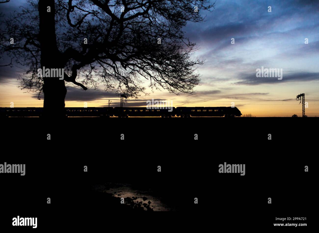 Avanti West Coast class 221 Bombardier diesel voyager train on the west coast mainline making a sunset silhouette running empty Stock Photo