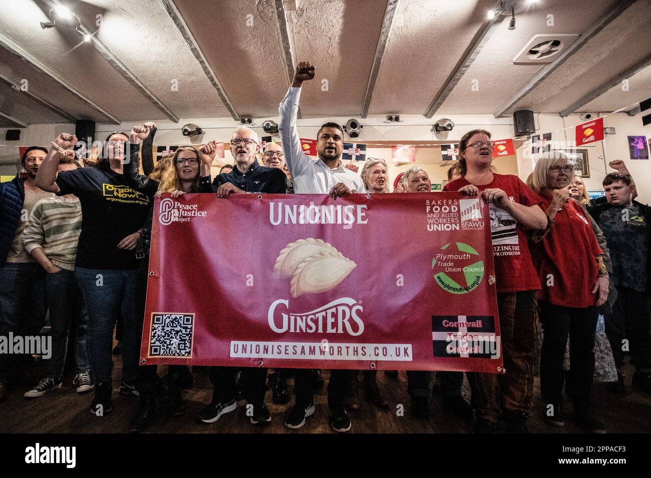Former Labour leader Jeremy Corbyn MP stands alongside members of the public inside the Callington Social Club in Callington, North Cornwall as staff vote on the unionisation of the factory. Stock Photo